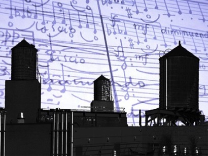 Brooklyn watertowers in sihouette in front of blue music score.